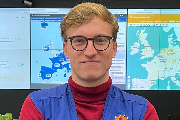 A young man on a background of world maps